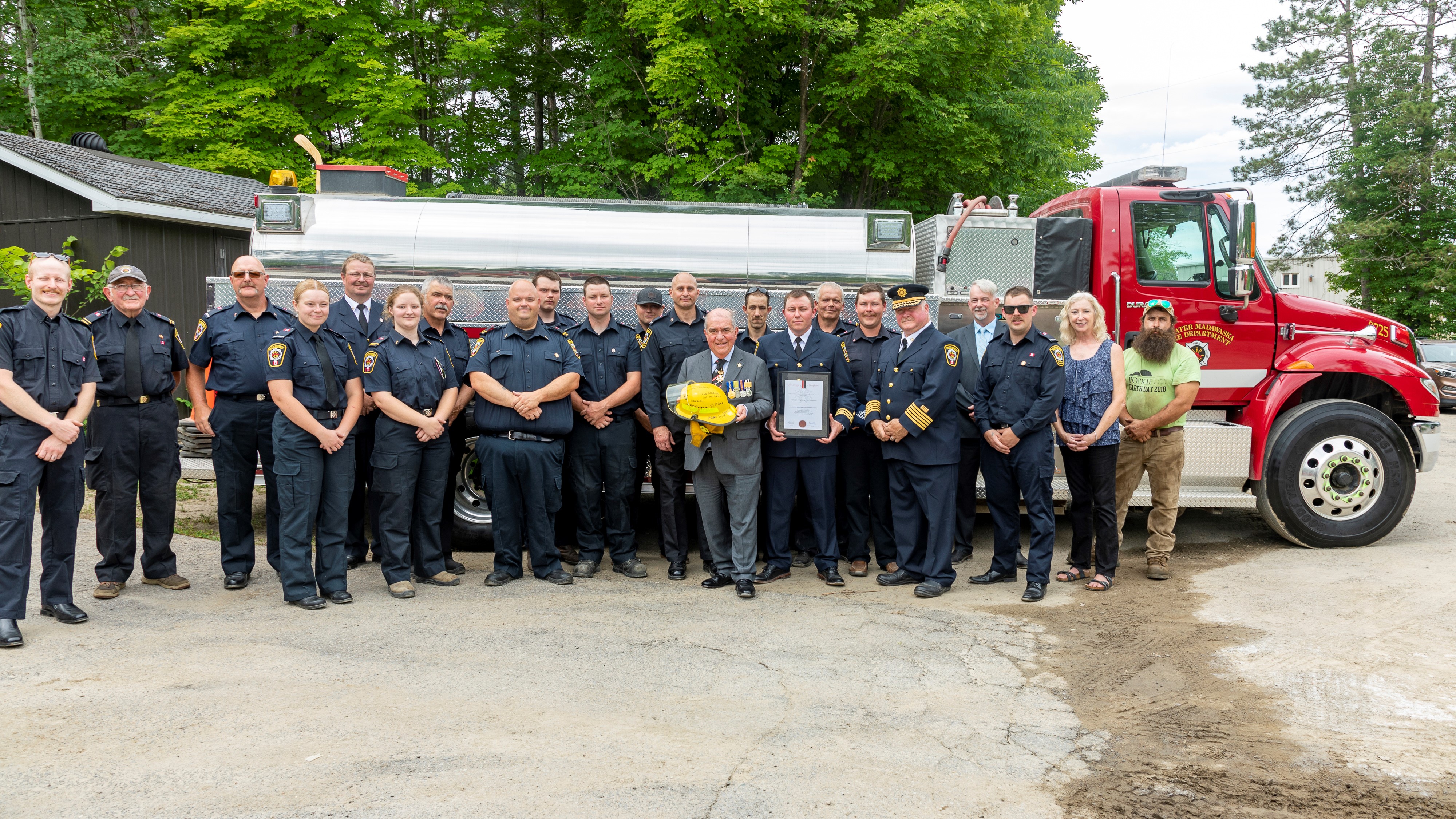 group of fire fighters standing in front of fire truck