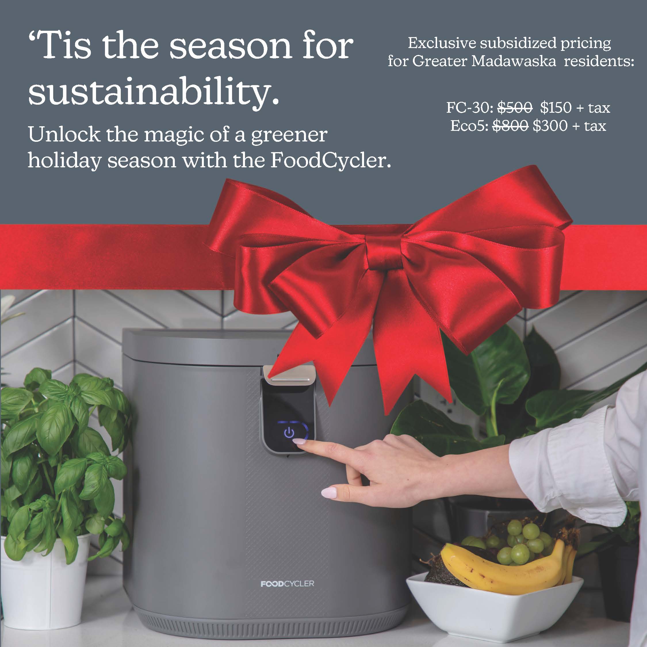 foodcycler unit with red bow, pointing hand, gray background