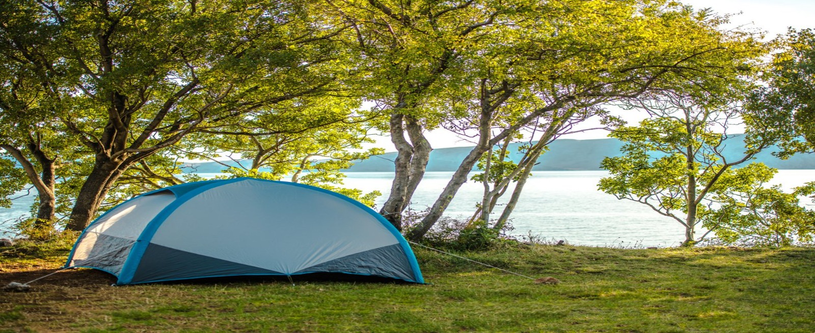 a tent sitting on the river side