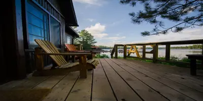 chairs on a deck over looking lake